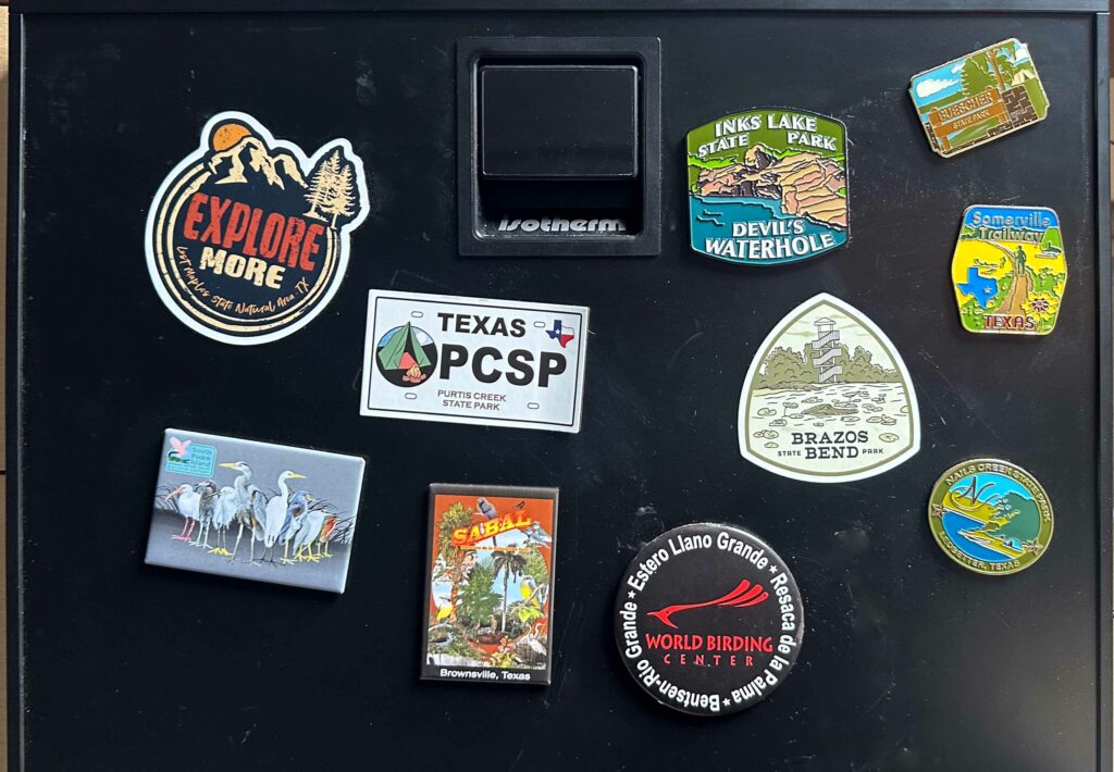 Magnets on a camping fridge from Texas State Parks and the World Birding Center